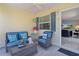 Cozy, well-decorated screened in patio with comfortable seating offering an inviting space to relax and unwind at 3756 Viscaya Ct, The Villages, FL 32163