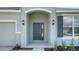 A welcoming covered entrance with a stylish front door and updated lighting fixtures at 4118 Penelope Ave, Lake Wales, FL 33859