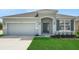 Charming single-story home with a well-manicured lawn, a two-car garage, and a welcoming front entrance at 4118 Penelope Ave, Lake Wales, FL 33859