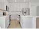 Modern kitchen with stainless steel appliances and white cabinets offers ample counter space at 4118 Penelope Ave, Lake Wales, FL 33859