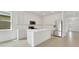 Bright kitchen boasts stainless steel appliances, large island, and white cabinetry at 4118 Penelope Ave, Lake Wales, FL 33859