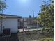 Backyard with pool partially obscured by a chain link fence and surrounding greenery at 4294 Nimons St, Orlando, FL 32811