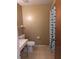 Standard bathroom featuring a toilet, vanity, and a shower with patterned curtain at 4294 Nimons St, Orlando, FL 32811