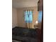 Bedroom with dark blue carpet and natural light from a window dressed with patterned curtains at 4294 Nimons St, Orlando, FL 32811