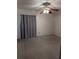 Bedroom with a ceiling fan, carpeted floor, and a window with curtains at 4294 Nimons St, Orlando, FL 32811