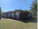 Exterior view of property showing the side of the house and the lawn at 4294 Nimons St, Orlando, FL 32811