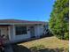 Modest home with green trim and front yard requiring some maintenance at 4294 Nimons St, Orlando, FL 32811