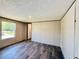 Bedroom boasts wood-look flooring and a window allowing for plenty of natural light at 43740 Sunset Dr, Paisley, FL 32767