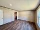 A bedroom with wood-look floors and neutral walls, offering a serene, adaptable space at 43740 Sunset Dr, Paisley, FL 32767