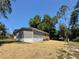 Side exterior view of home with new sod, offering a glimpse of the backyard and surroundings at 43740 Sunset Dr, Paisley, FL 32767