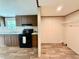 Well-lit kitchen features a stove and a storage area with shelving and wood-look flooring at 43740 Sunset Dr, Paisley, FL 32767