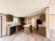 Open concept kitchen with wood cabinets, an island, and modern appliances, perfect for entertaining at 43740 Sunset Dr, Paisley, FL 32767