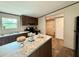 Modern kitchen with stainless steel appliances, granite countertops, a kitchen island and wood cabinets at 43740 Sunset Dr, Paisley, FL 32767