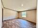 Spacious living room featuring new plank flooring and a large window at 43740 Sunset Dr, Paisley, FL 32767