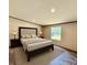 Comfortable main bedroom with a large bed, soft lighting, and a serene ambiance at 43740 Sunset Dr, Paisley, FL 32767