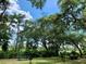 Picturesque view of a recreation area with shade trees, picnic benches and lake access at 43740 Sunset Dr, Paisley, FL 32767