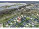 Aerial view of a lakeside community boasting well-maintained homes with landscaped yards at 4406 Creighton Loop, The Villages, FL 32163