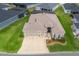 Aerial view of a well-maintained home showcasing its manicured lawn, three-car garage, and landscaping at 4406 Creighton Loop, The Villages, FL 32163