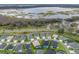 Aerial view of houses in a lakeside community with well-manicured lawns and tree coverage at 4406 Creighton Loop, The Villages, FL 32163
