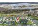 Aerial view of a community featuring houses and a scenic view of a lake nearby at 4406 Creighton Loop, The Villages, FL 32163