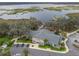 Aerial shot of a lakefront community clubhouse featuring ample parking and water views at 4406 Creighton Loop, The Villages, FL 32163