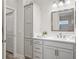 Bathroom with storage cabinets, white countertop, and silver hardware at 4406 Creighton Loop, The Villages, FL 32163
