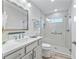 Modern bathroom with a glass-enclosed shower, white vanity, and updated fixtures at 4406 Creighton Loop, The Villages, FL 32163