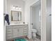 Bathroom with vanity, light fixtures, and neutral tile at 4406 Creighton Loop, The Villages, FL 32163