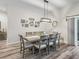 Dining room with a large table and views of the backyard; picture gallery on the wall at 4406 Creighton Loop, The Villages, FL 32163