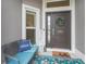 Inviting front porch with a cozy bench, decorative pillows, and a welcoming 'hello' doormat at 4406 Creighton Loop, The Villages, FL 32163