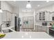 Modern kitchen featuring stainless steel appliances, ample cabinetry, and stylish countertops at 4406 Creighton Loop, The Villages, FL 32163