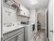 Well-organized laundry room with ample storage cabinets and a convenient utility sink at 4406 Creighton Loop, The Villages, FL 32163