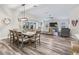 Open-concept living and dining area with modern lighting and neutral decor; views of pool area at 4406 Creighton Loop, The Villages, FL 32163