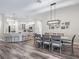 Open-concept layout of kitchen, dining, and living areas with a breakfast bar; great for entertaining at 4406 Creighton Loop, The Villages, FL 32163