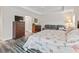 Comfortable main bedroom with wood floors, TV, and sofa for relaxing at 4406 Creighton Loop, The Villages, FL 32163