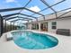 Enjoy this screened-in pool with waterfall feature and sunbathing bench for relaxing on hot days at 4406 Creighton Loop, The Villages, FL 32163
