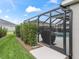 Exterior view of the screened-in lanai with a glimpse of the inviting pool area at 4406 Creighton Loop, The Villages, FL 32163