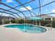 Private screened-in pool area with water feature, landscaping, and ample deck space at 4406 Creighton Loop, The Villages, FL 32163