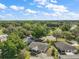 Aerial view of multiple homes surrounded by lush trees and landscaping in a neighborhood setting at 4553 Belle Grv, Leesburg, FL 34748
