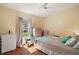 Sunlit bedroom with wood floors, complemented by neutral tones and a comfortable, inviting space at 4553 Belle Grv, Leesburg, FL 34748