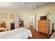 Bright bedroom with wood floors, featuring an open layout and views to other spaces, perfect for relaxation at 4553 Belle Grv, Leesburg, FL 34748