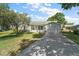 Charming single-story home with a well-manicured lawn, attached garage, and inviting front entrance at 4553 Belle Grv, Leesburg, FL 34748