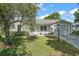 Well maintained single story home with attached garage, lush front lawn and manicured bushes at 4553 Belle Grv, Leesburg, FL 34748