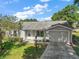 Charming single-story home with a well-manicured lawn, attached garage, and inviting front entrance at 4553 Belle Grv, Leesburg, FL 34748