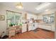 Charming kitchen with white cabinets, wood floors, and a cozy breakfast nook at 4553 Belle Grv, Leesburg, FL 34748