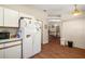 Bright kitchen featuring white appliances, laminate counters, and wood flooring at 4553 Belle Grv, Leesburg, FL 34748