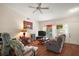 Inviting living room with a ceiling fan, wood floors, and a comfortable seating area at 4553 Belle Grv, Leesburg, FL 34748