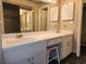 Bathroom featuring dual sinks, vanity and ample storage for all your essentials with a classic stool at 500 Newell Hill Rd # D, Leesburg, FL 34748