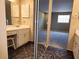 Bathroom with a vanity, decorative mirror, and a peek into a bedroom, offering both functionality and style at 500 Newell Hill Rd # D, Leesburg, FL 34748