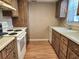 Functional kitchen with laminate cabinets, a range, and essential appliances at 500 Newell Hill Rd # D, Leesburg, FL 34748